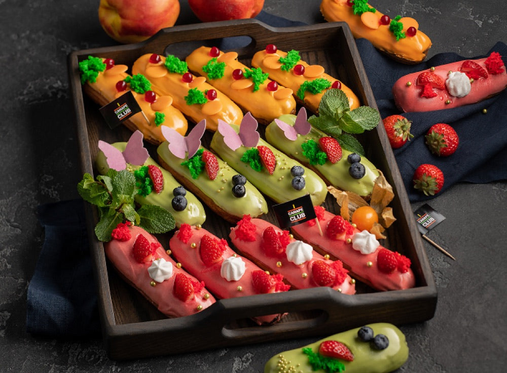 Colorful éclairs with fresh toppings